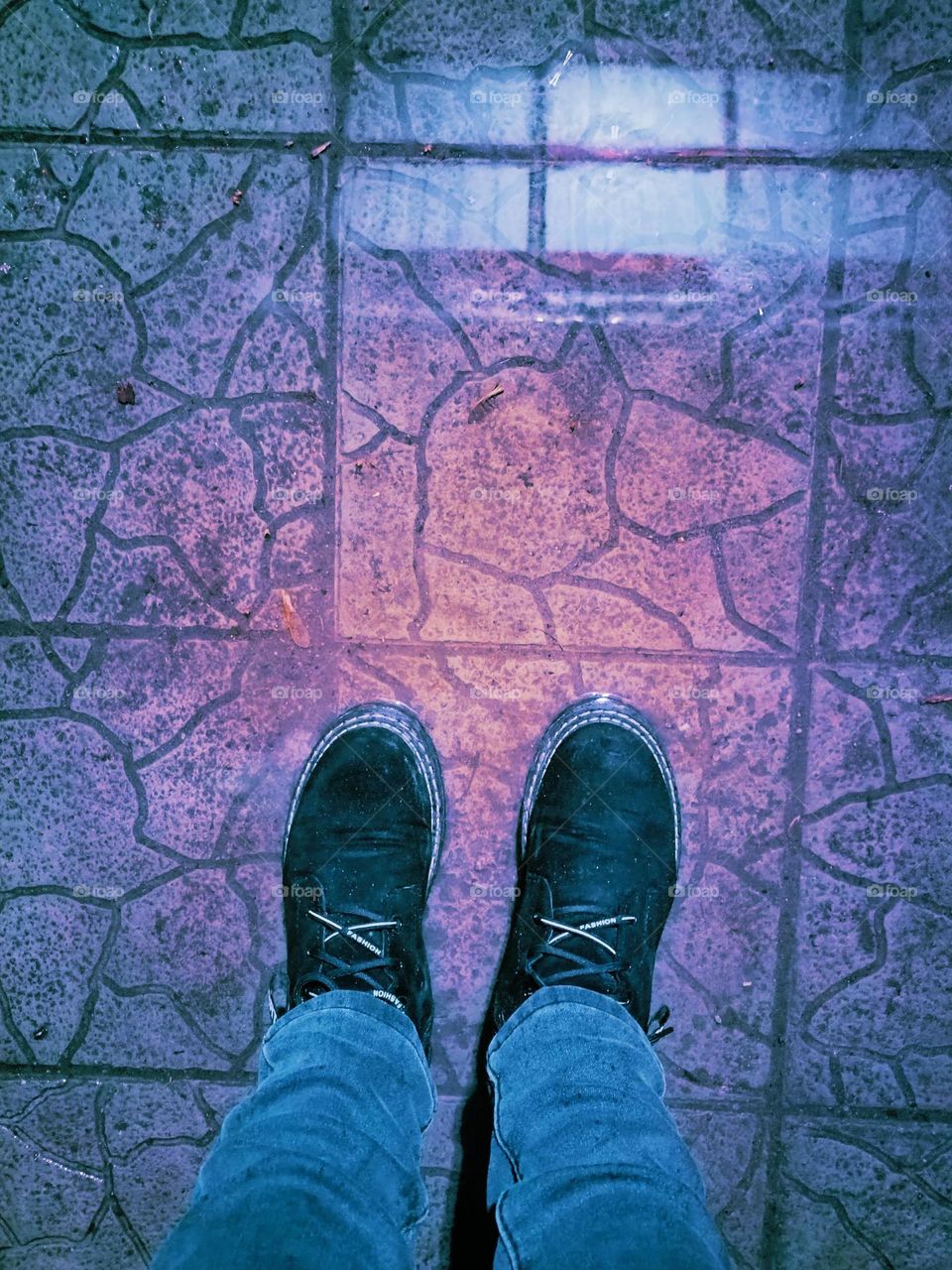 I'm standing in a puddle in front of my house in suede boots. Evening, feet in boots, black boots, road.