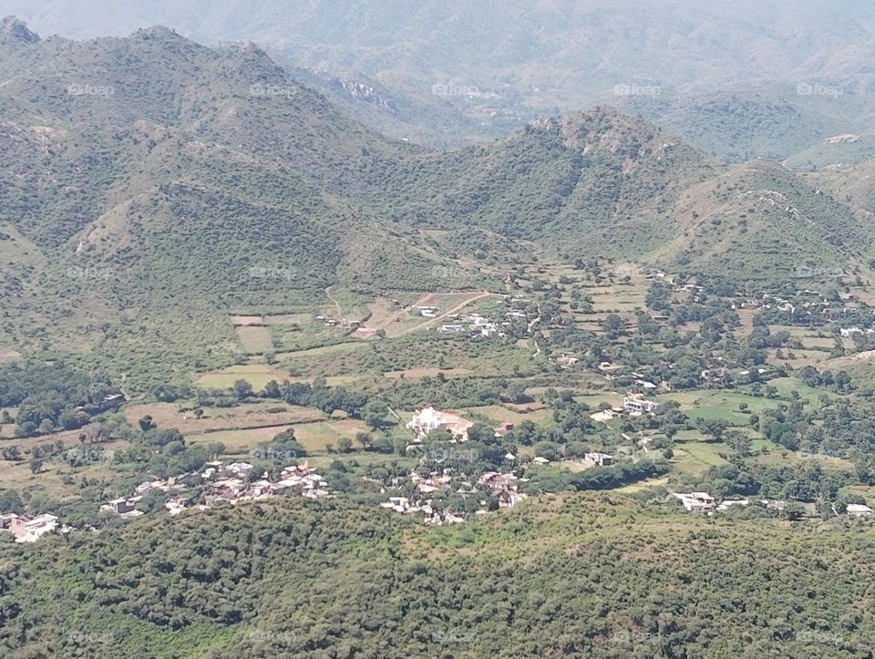 a valley scene, picturise from very high distance, green plant, everything looks very small size