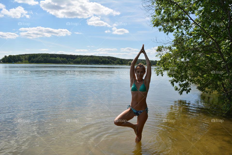 woman on a lake shore happiness