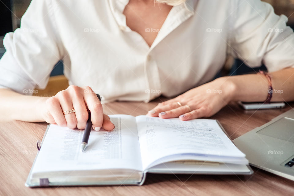 Woman’s hands making notes. Business woman 