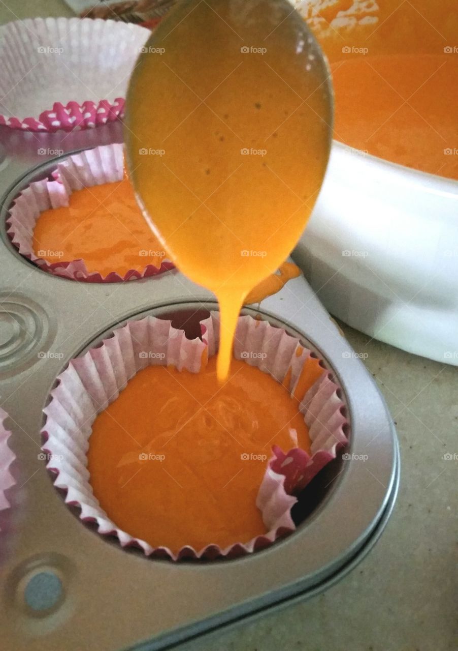 Pouring cupcake mix