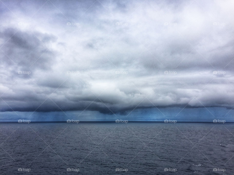 Rain falling in the distance over the open ocean 
