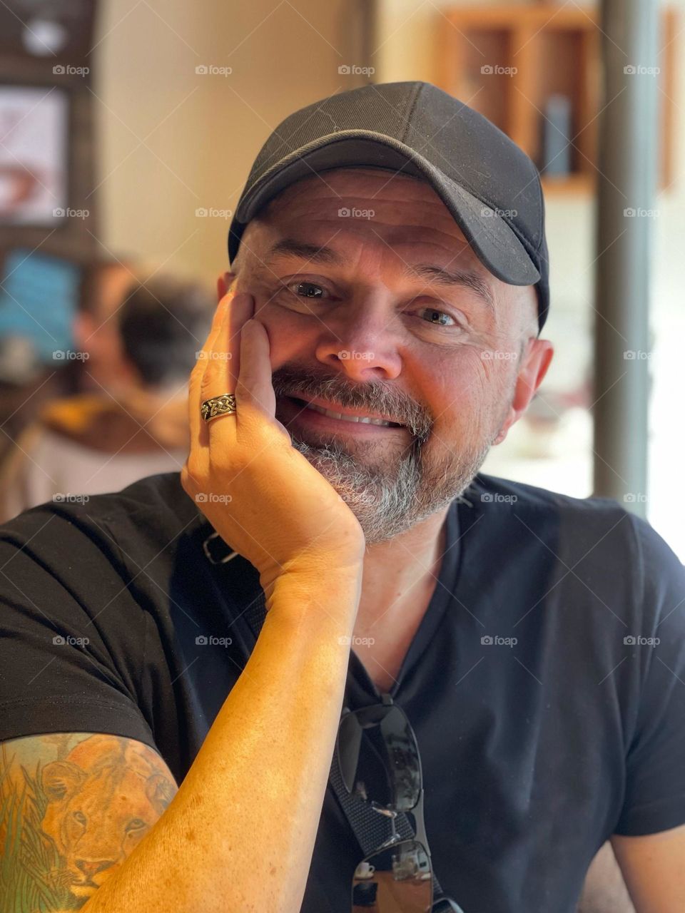 Portrait of smiling man in a black cap