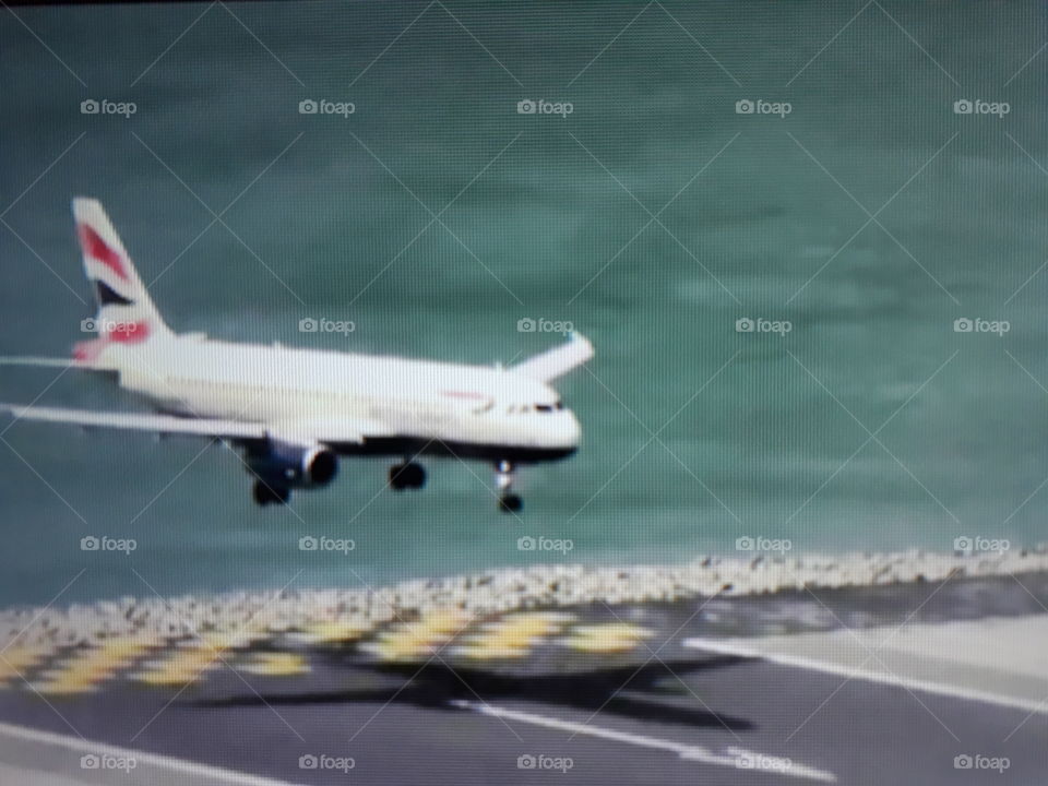 A large plane arriving at its destination making an exciting landing a beautiful sight to behold.