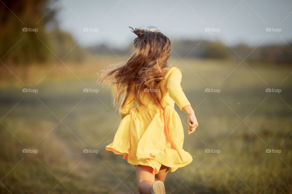 Little girl in yellow dress outdoor portrait 