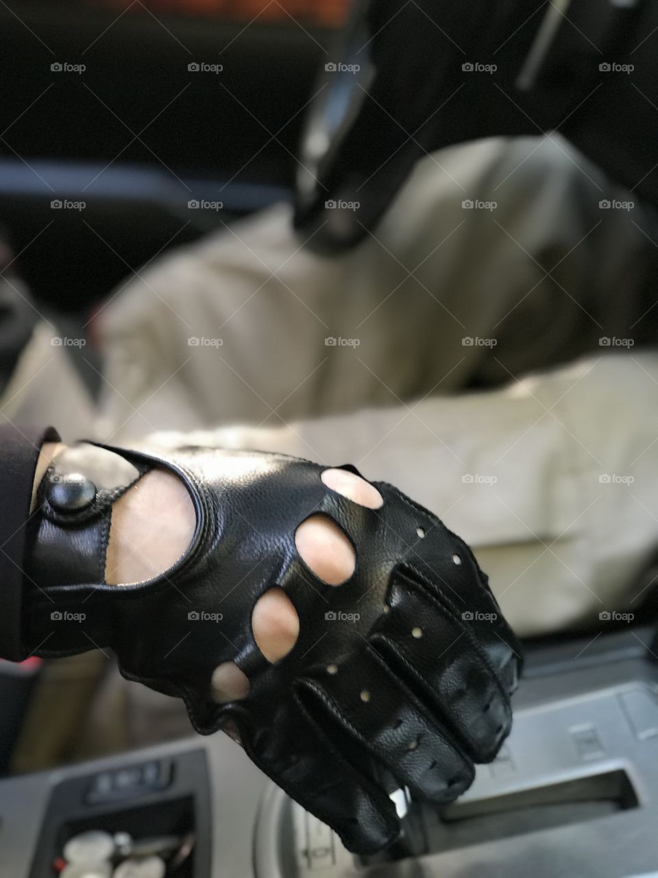 Man leaving for work with one hand on steering wheel and one hand on shifter