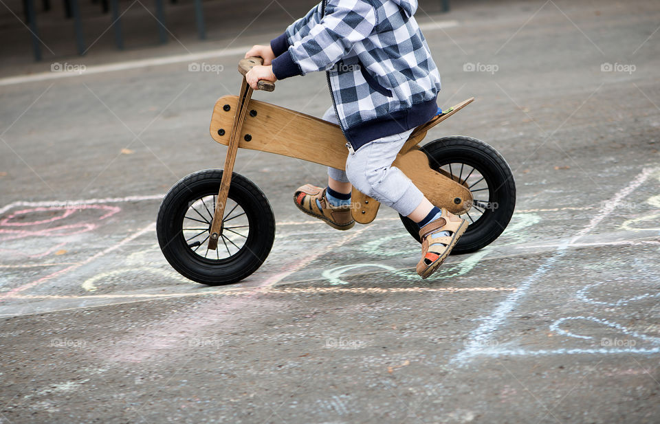 Child on wooden bicylce