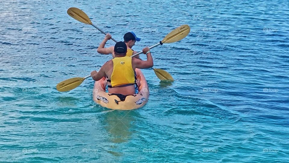 Father and Son Canoeing in the Bahamian water Nassau Bahamas