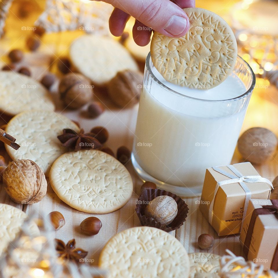 Person dipping in glass of milk