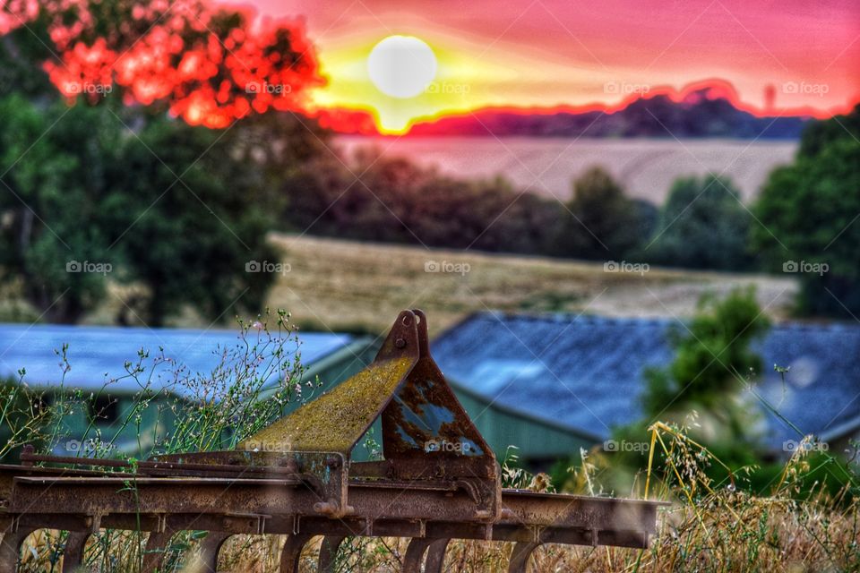 farm landscape with old rusty machinery
