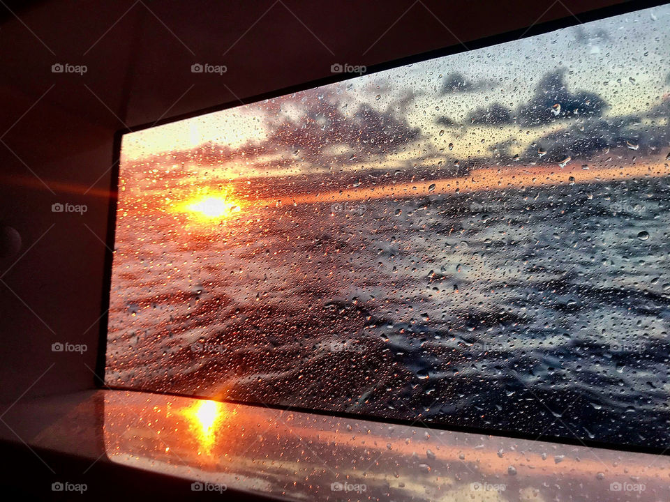 view of the sunset inside a cabin of a sailboat