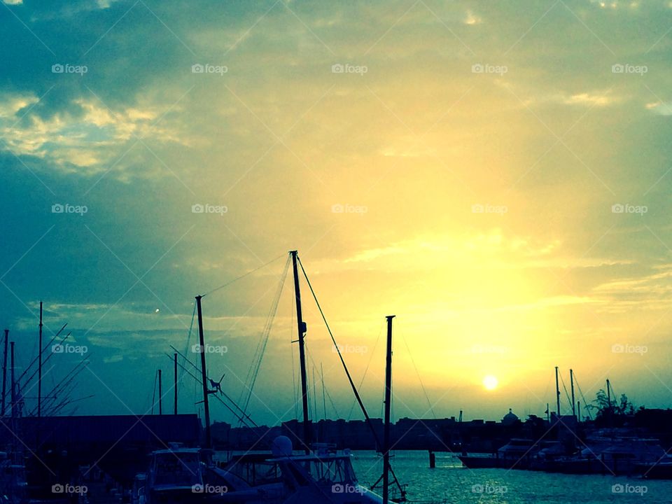 Sun Rays over the Marina. The exact moment when the sun began to disappear over a marina in San Juan, Puerto Rico.