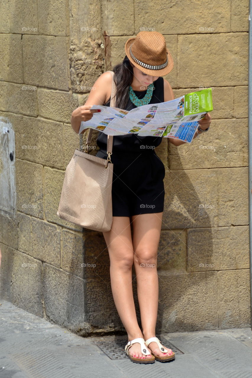 a woman tourist visiting the city consults a map