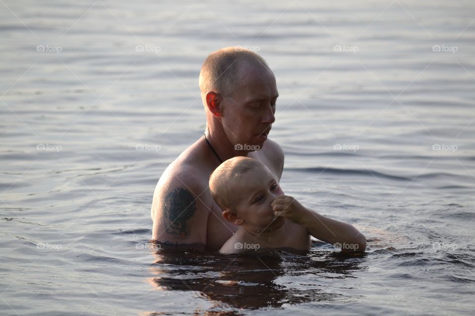 Father and son. Father and son bathing in the lake