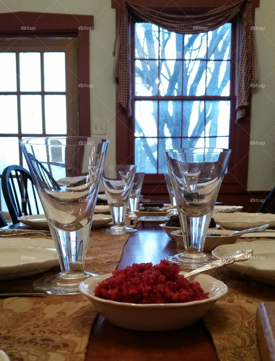 clear glassware and white plates on wood table