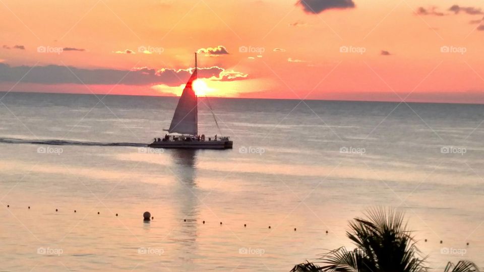 Red Sails in the Sunset. A sailboat returning home after a day sail.