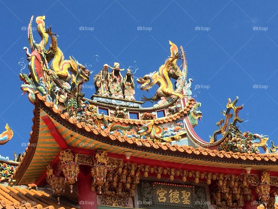Ornate decor of ancient temples stand tall against the sky in Taiwan
