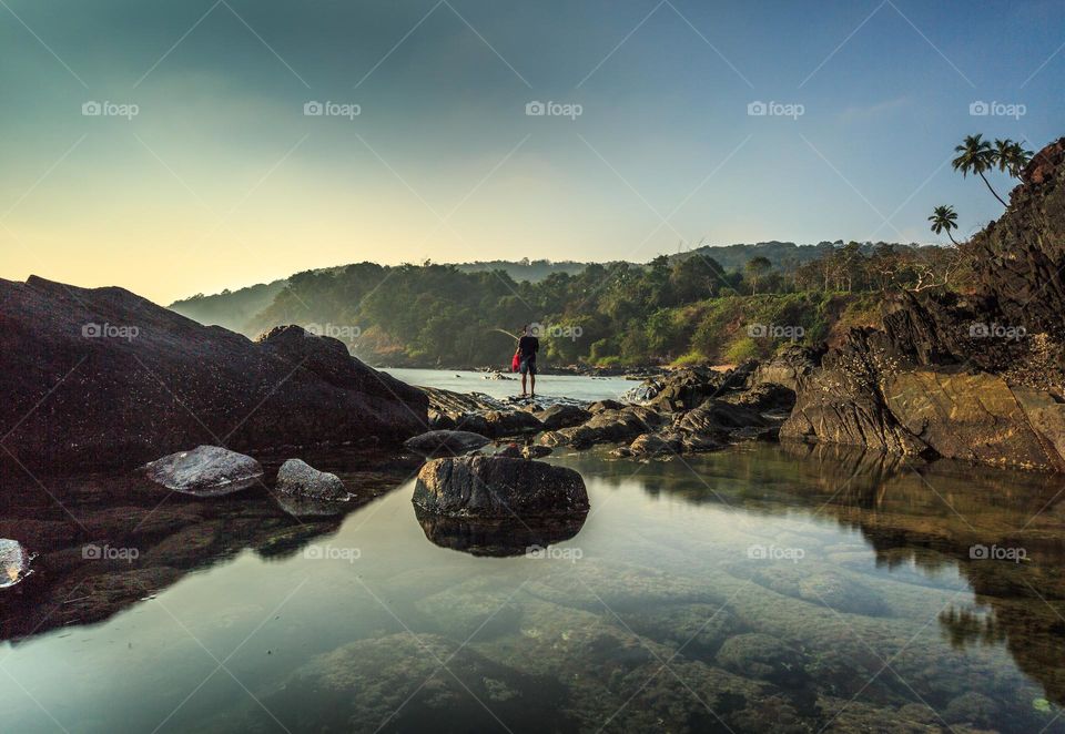 man fishing by the sea