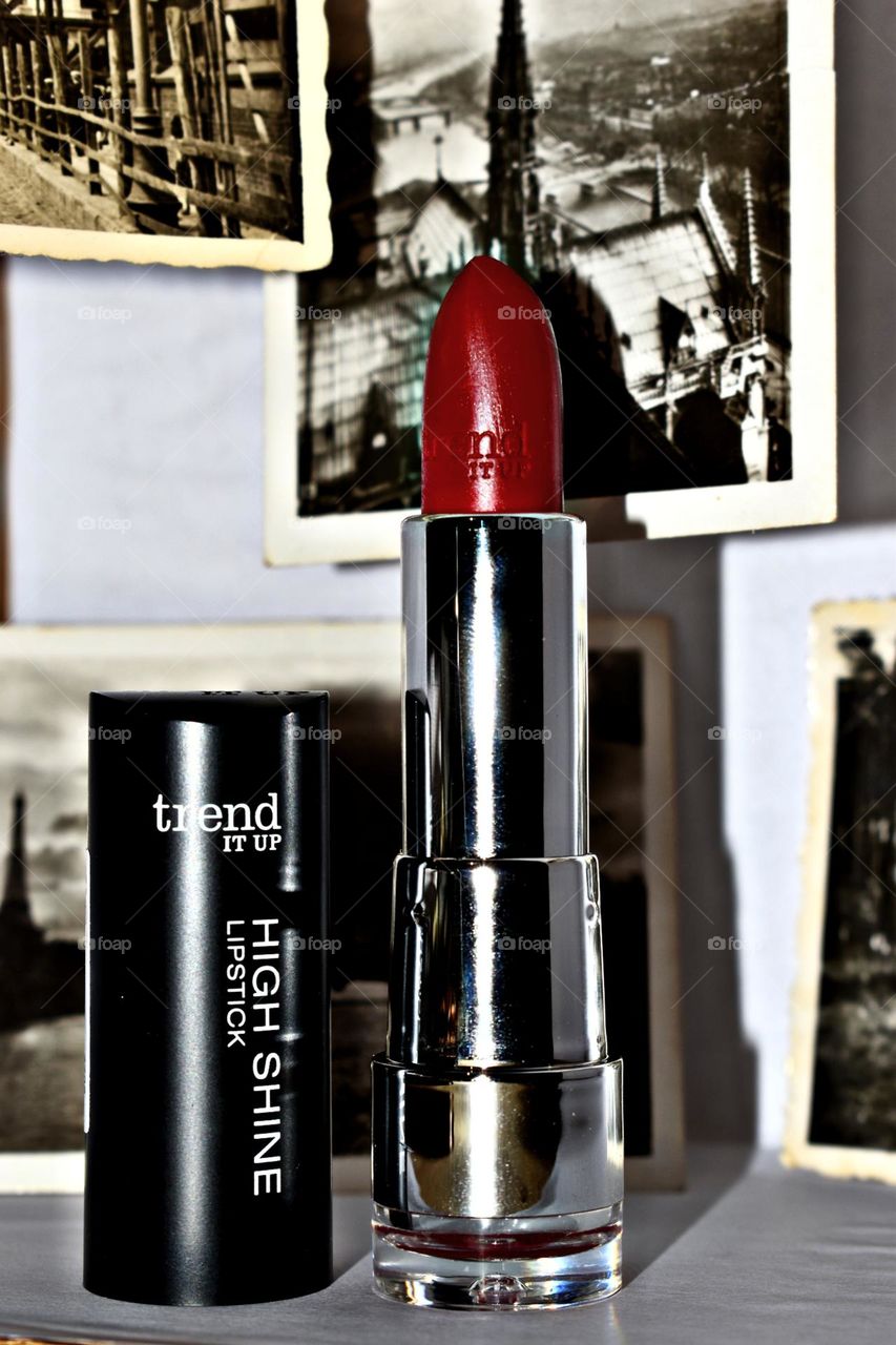 Red lipstick with old pictures in the background.