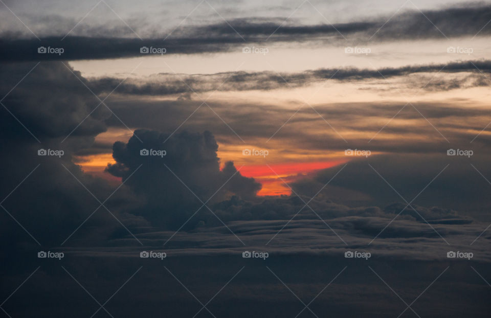 Aerial view of sunset, above clouds