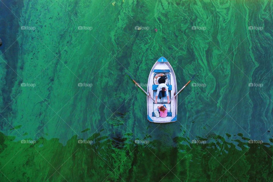 boat on green water Dnieper river Kiev city