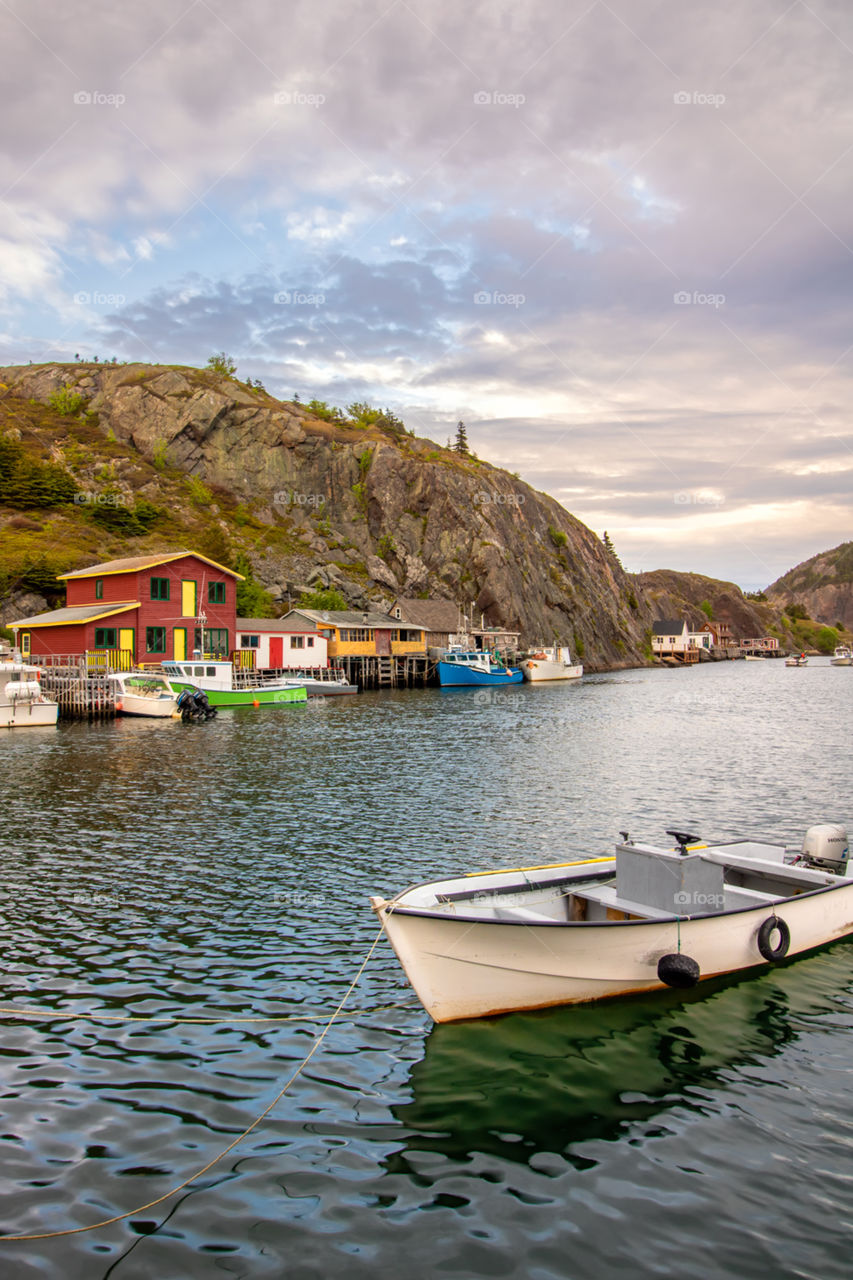 Sunset over the picturesque small fishing village of Quidi Vidi located in Newfoundland Canada, with colorful houses lining the shore. 