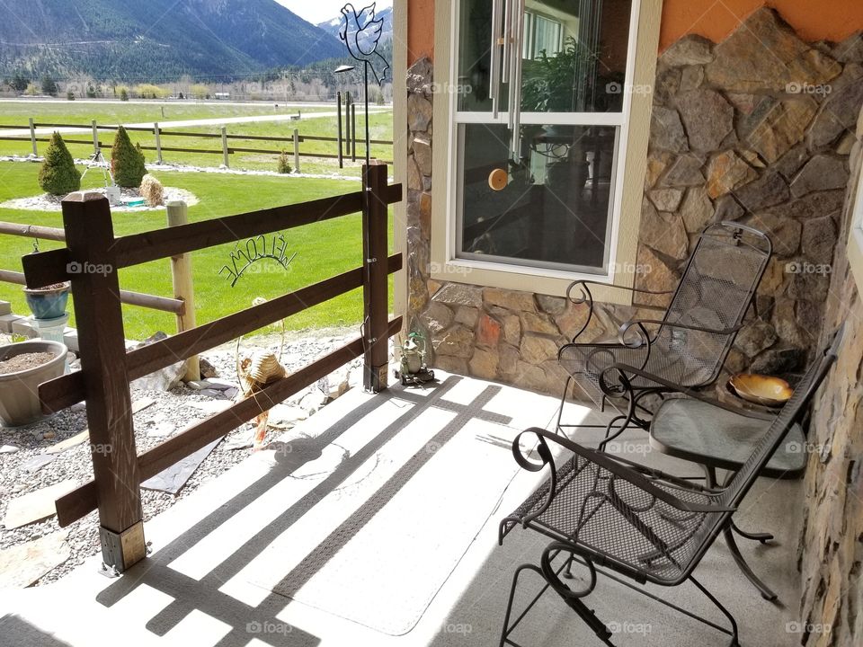 front porch overlooking a sunny Andes gem yard with gorgeous mountains in the background,  warm and sunny in the cool mornings, shaded in the evenings for a cool summer eve, can have a nice chat while sipping ice cold tea or lemonade. it's that spot!