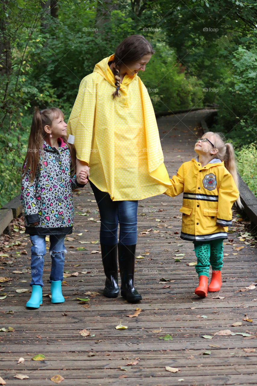 woman walking hand in hand with two children