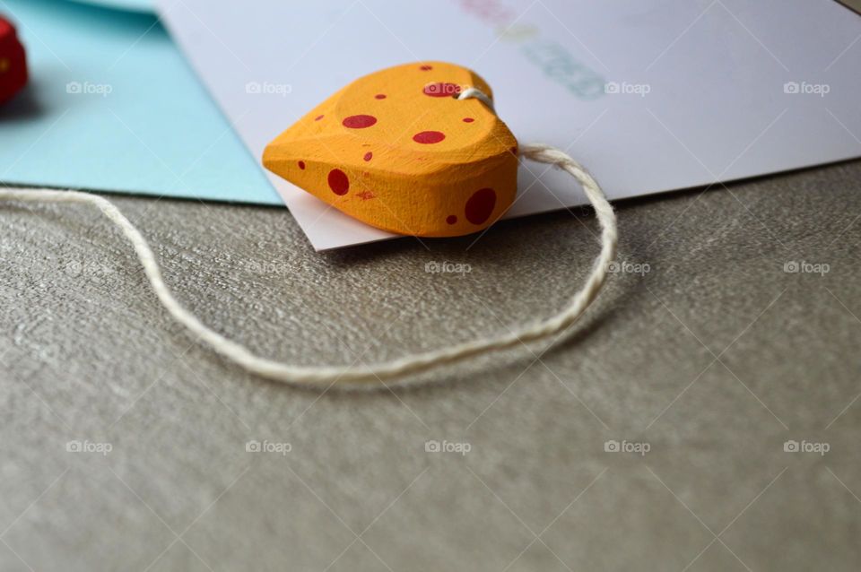 Multicolored wooden hearts near a greeting card