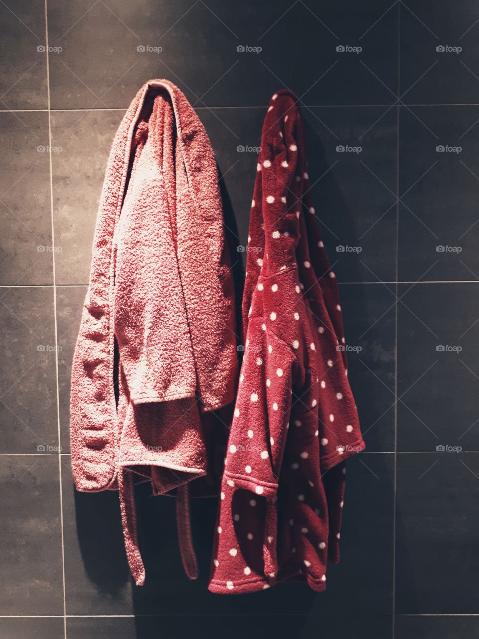 Kids bathrobe hanging in bathroom.