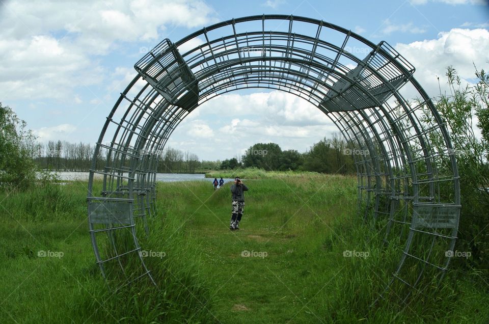 A photographer in a meadow in Holland.