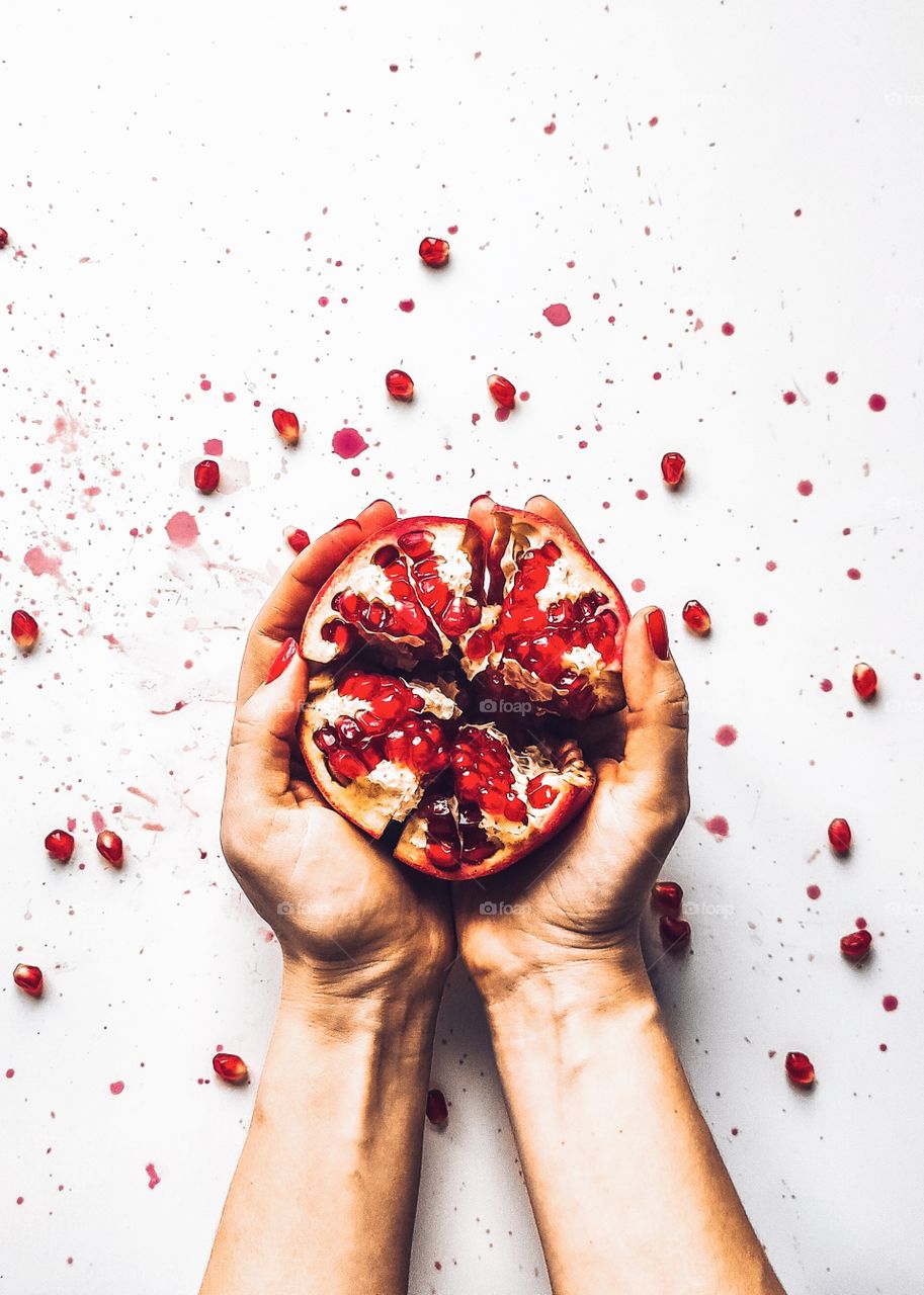 Pomegranate fruit in female hands