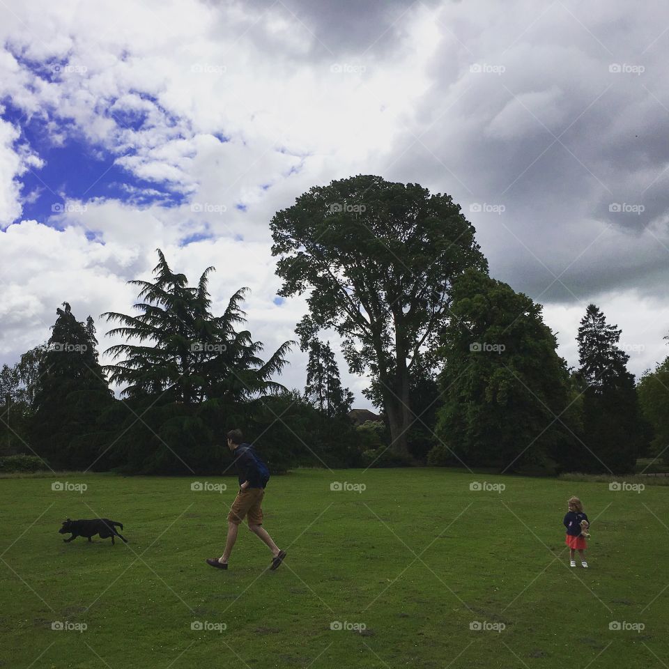 Dog and child walking, Hatherley Park, UK