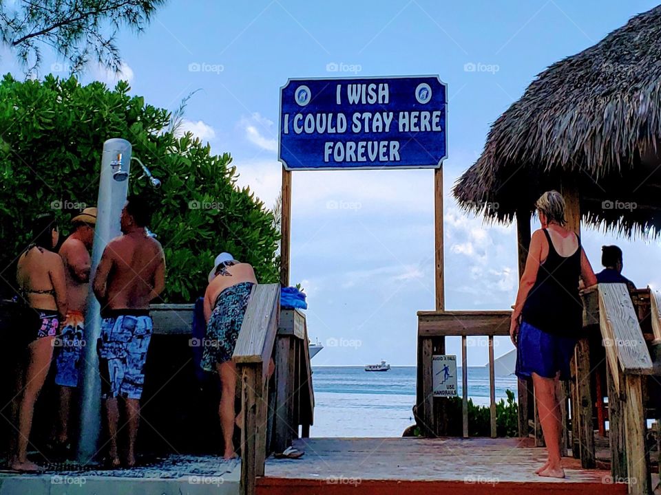 Unrecognizable people rinsing their feet after a day on the beach vacationing in Grand Turks Caicos Island