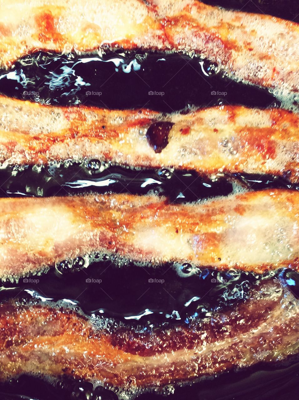 Bacon sizzling in neon filter