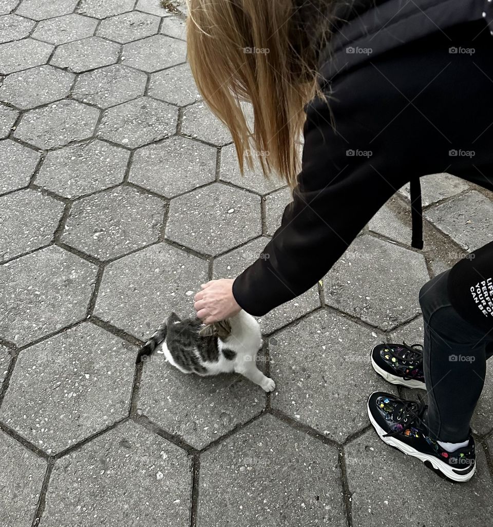 A woman playing with a cat.