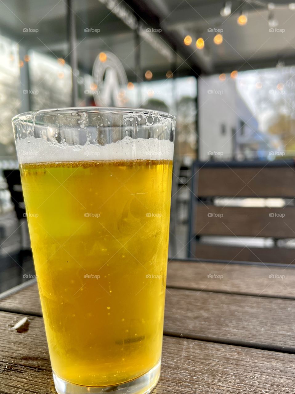 Closeup beer in glass on outdoor cafe table 