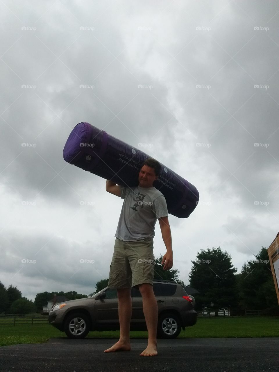 a man taking delivery of a purple mattress