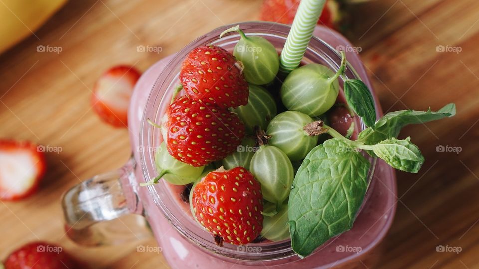 Gooseberries and strawberries on mason jar