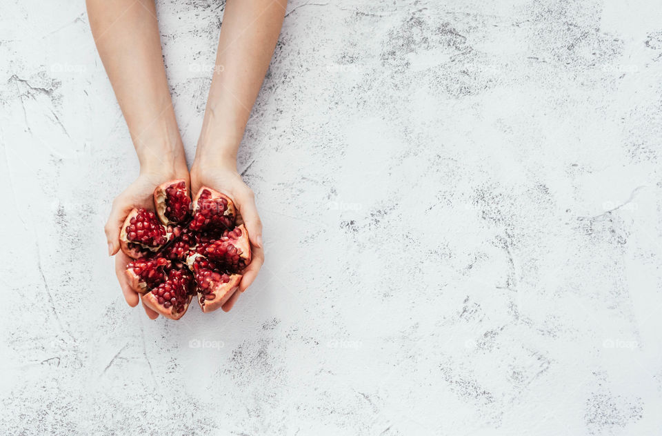 female hands with pomegranate