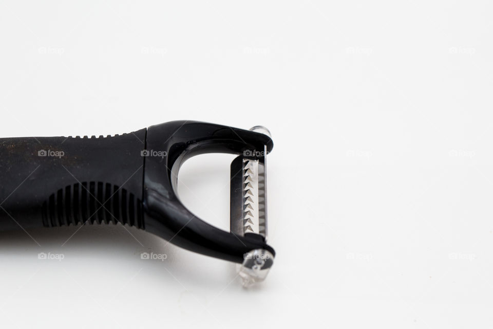 Product kitchen utensil - black peeler on pure white background.