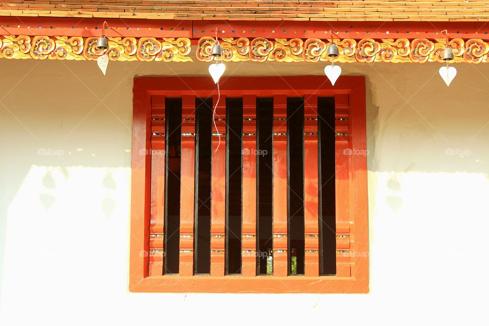 Beauty wooden red window in the Thai temple.