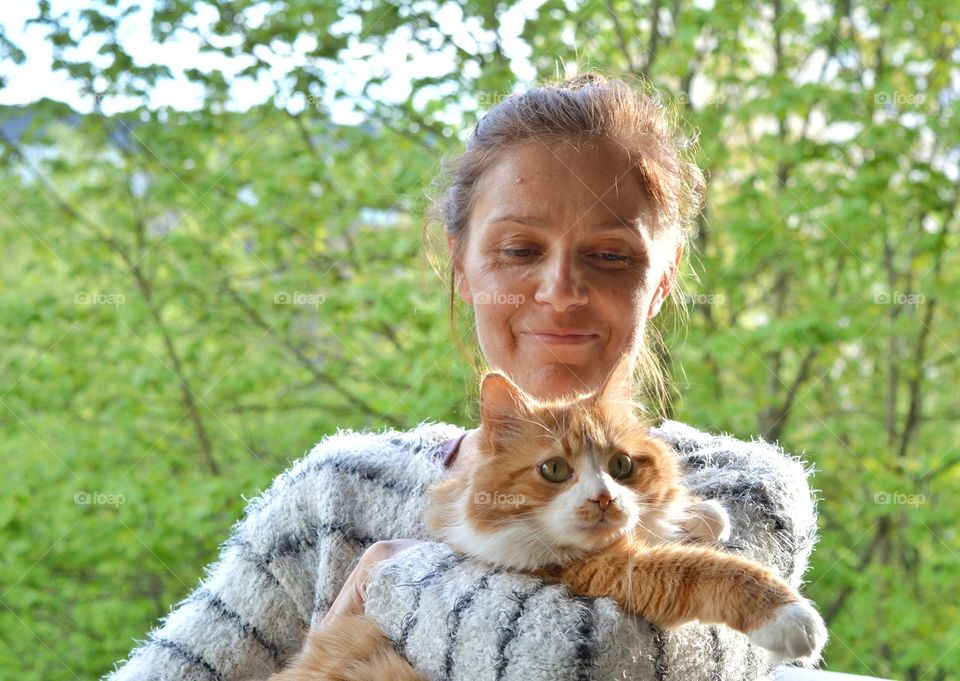 girl with cat love pet green background