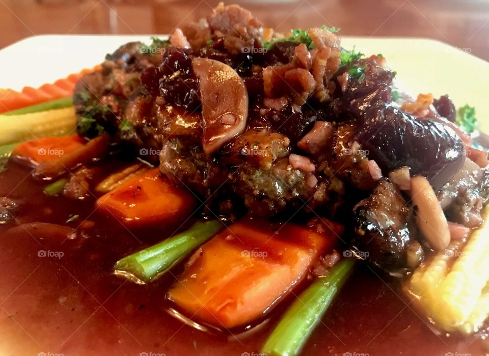 Duck roast steak with cherry sauce and red wine that you can find in Italian restaurant in Thailand