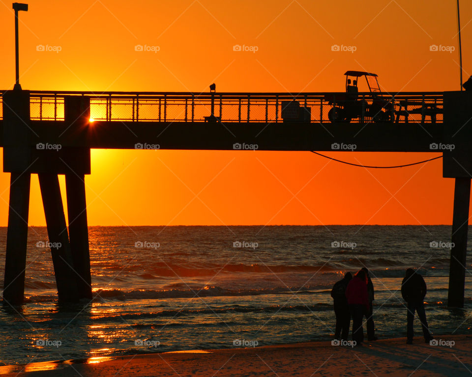 Salt air filled my lungs as I prepared to capture the magnificent sunset over the silhouette pier!