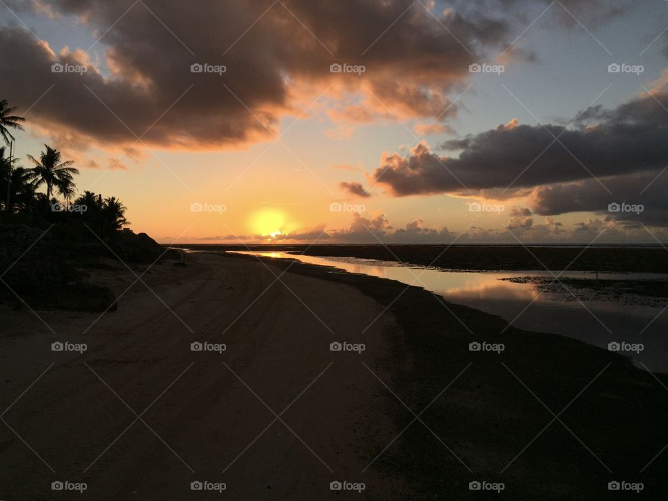 Sunset over the Guam coast reflecting on the ocean below.