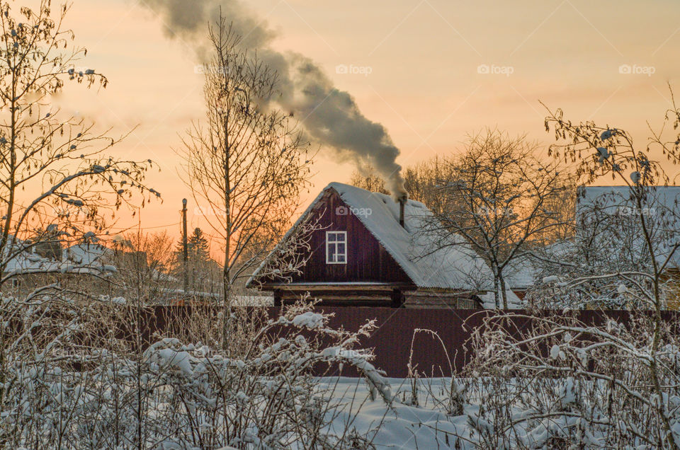 Winter landscape with a rustic house. Winter season. Cold weather.