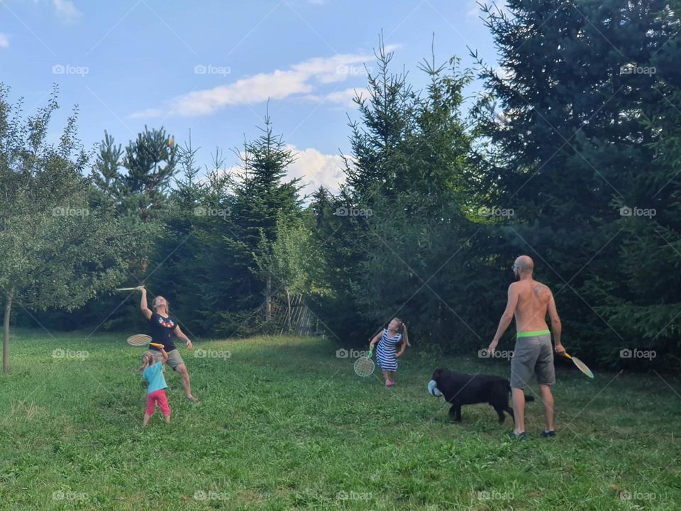 Happy to be together in the middle of nature p, playing badminton