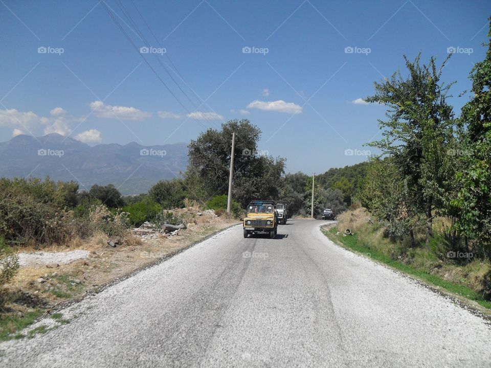 Jeep on the road with mountains behind in Turkey