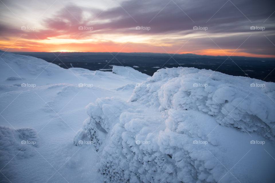 Sunsets from mountain tops are even better in the winter and the rocks have a frozen layer of ice and snow over them